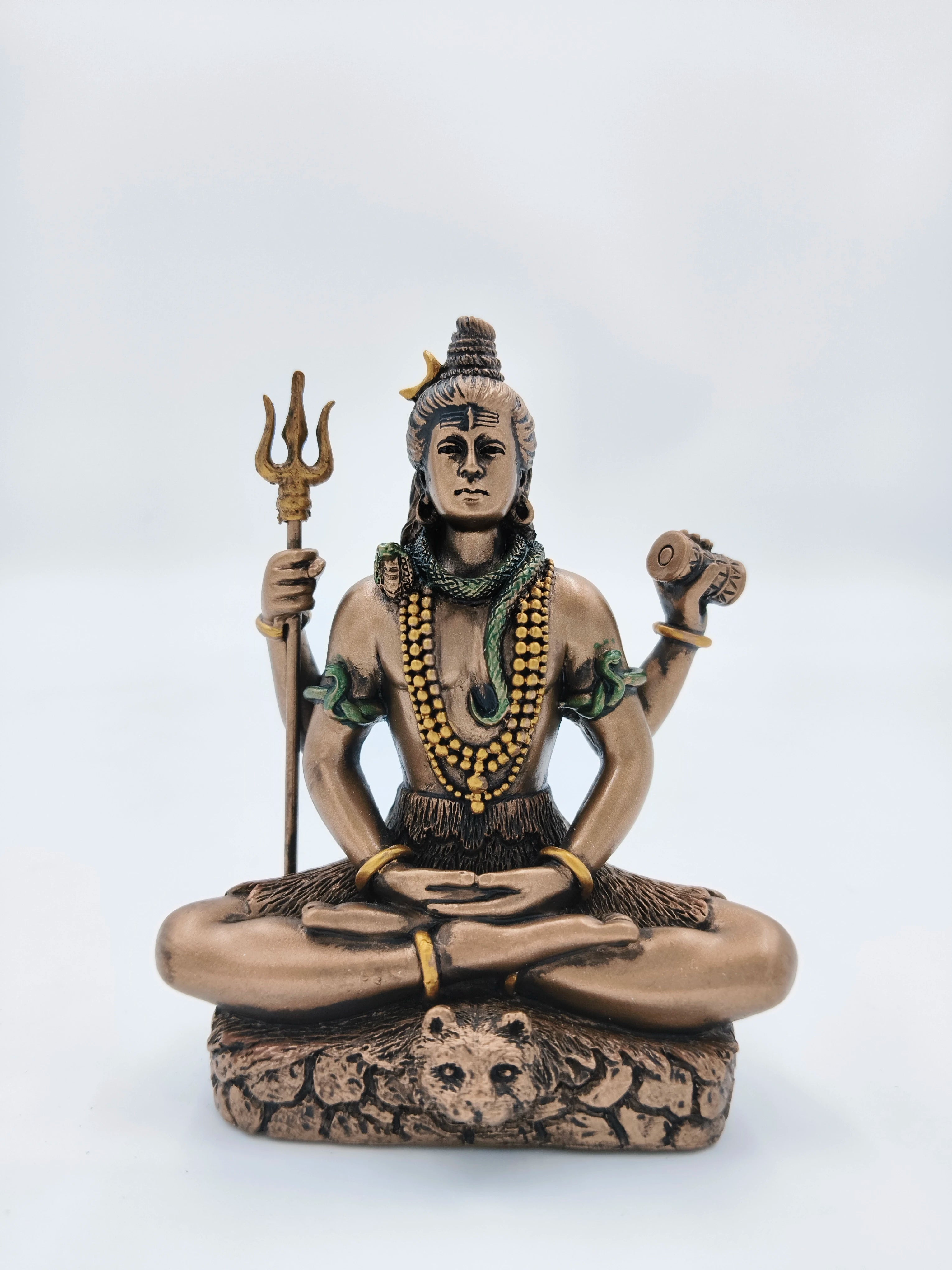 Small polyresin Shiva statue seated in meditation with trident and drum