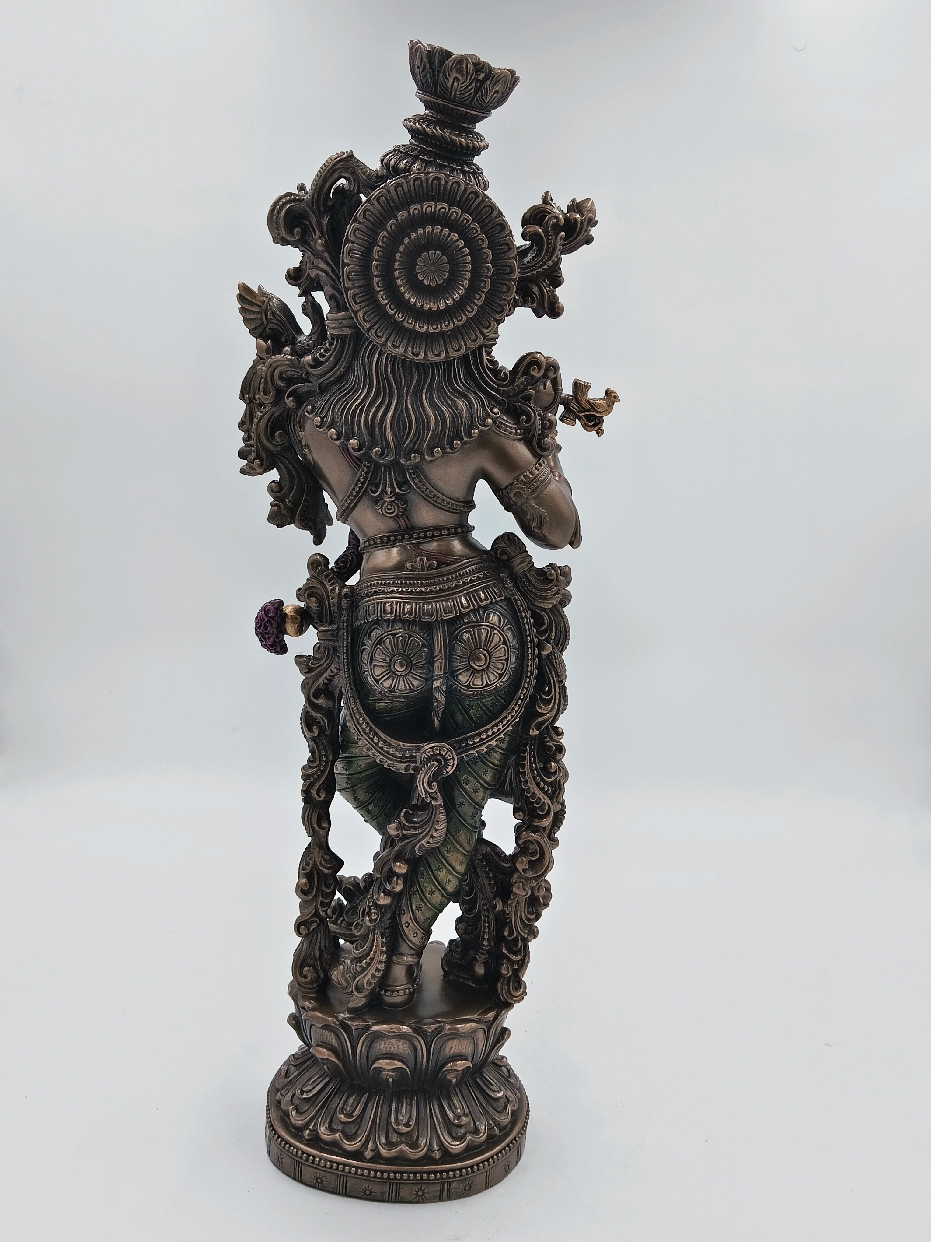 Back view of large polyresin Krishna sculpture with detailed ornamental design