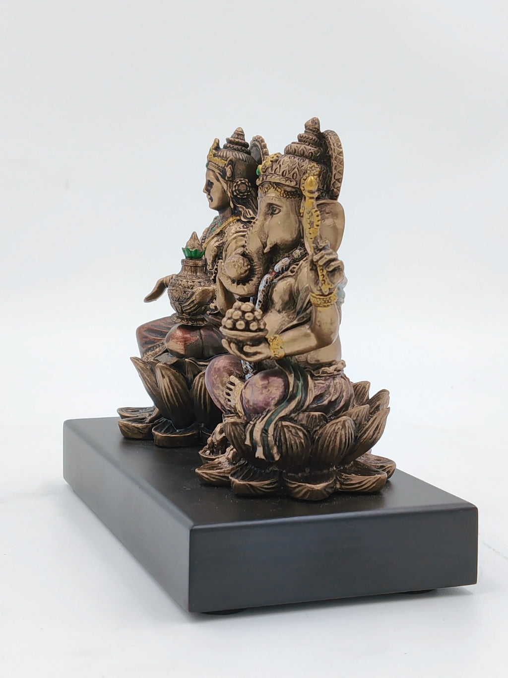 Small polyresin statue of Lord Ganesh and Goddess Lakshmi seated on lotus on a black base
