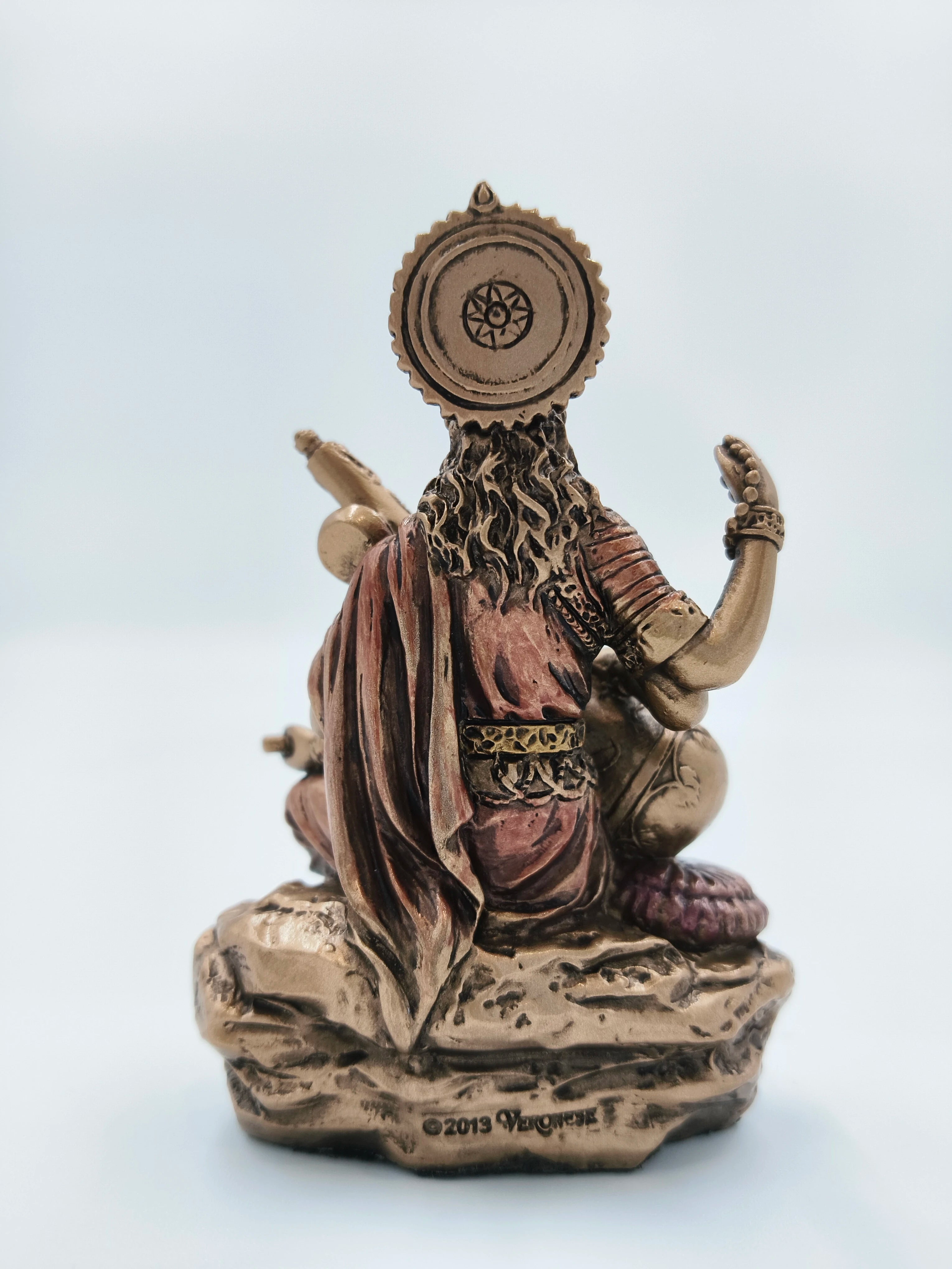 Back view of small polyresin Saraswathi statue with detailed clothing and ornaments