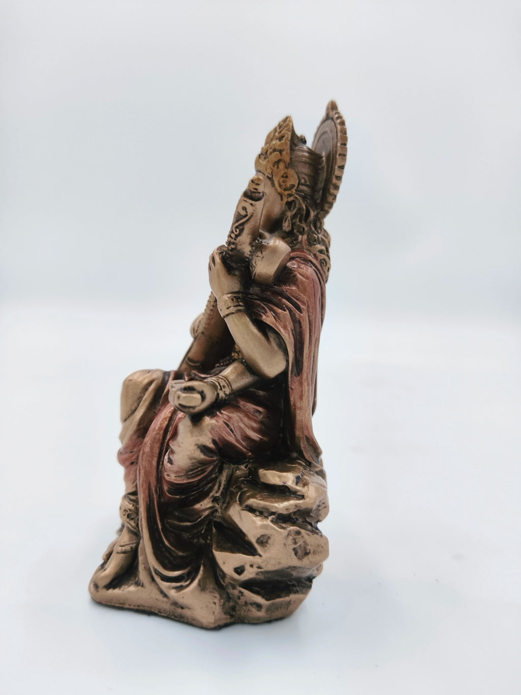 Side view of small polyresin Saraswathi statue with intricate details