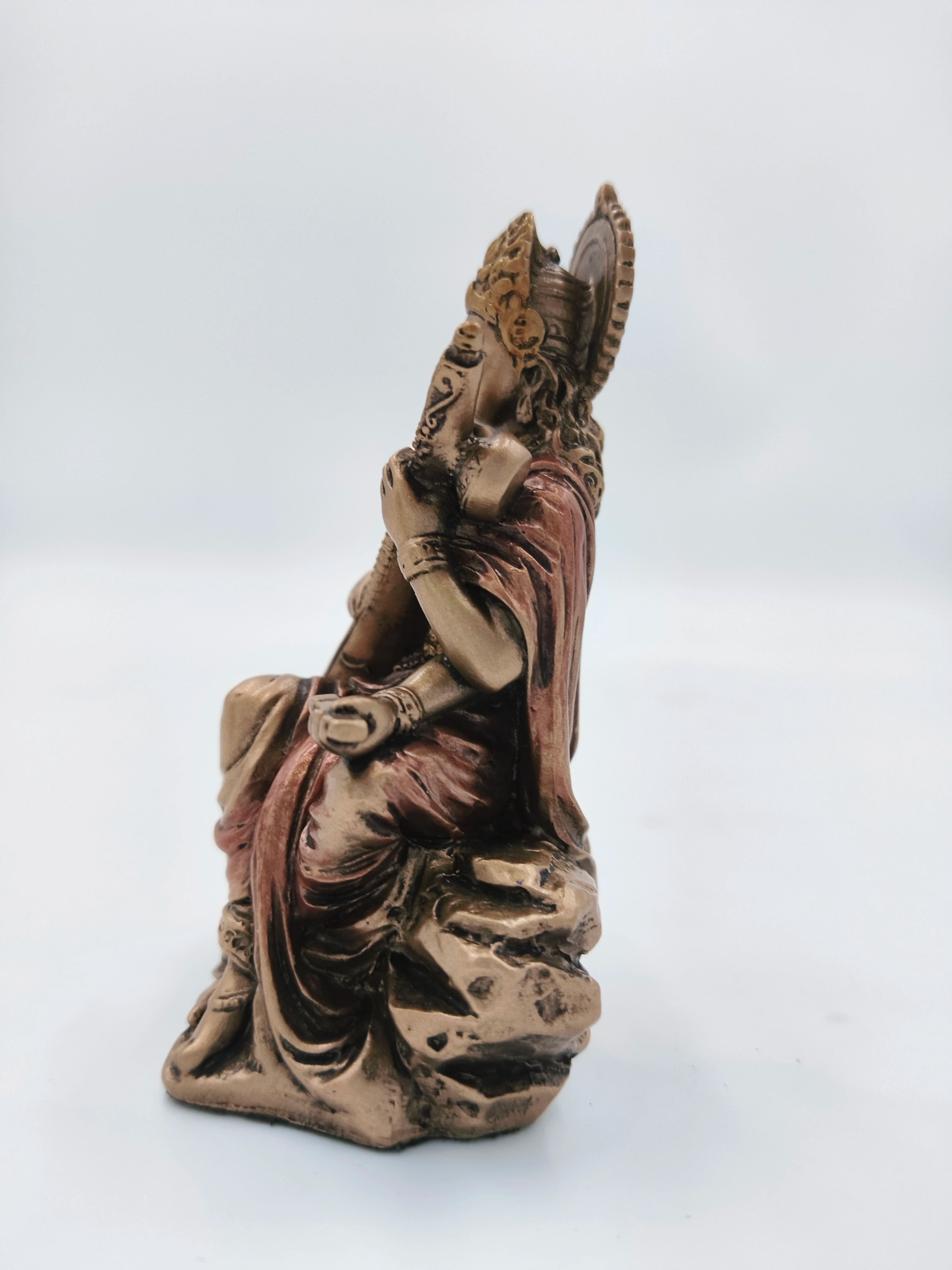 Side view of small polyresin Saraswathi statue with intricate details