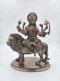 Polyresin sculpture of Durga Maa sitting on a lion with multiple arms holding symbolic items