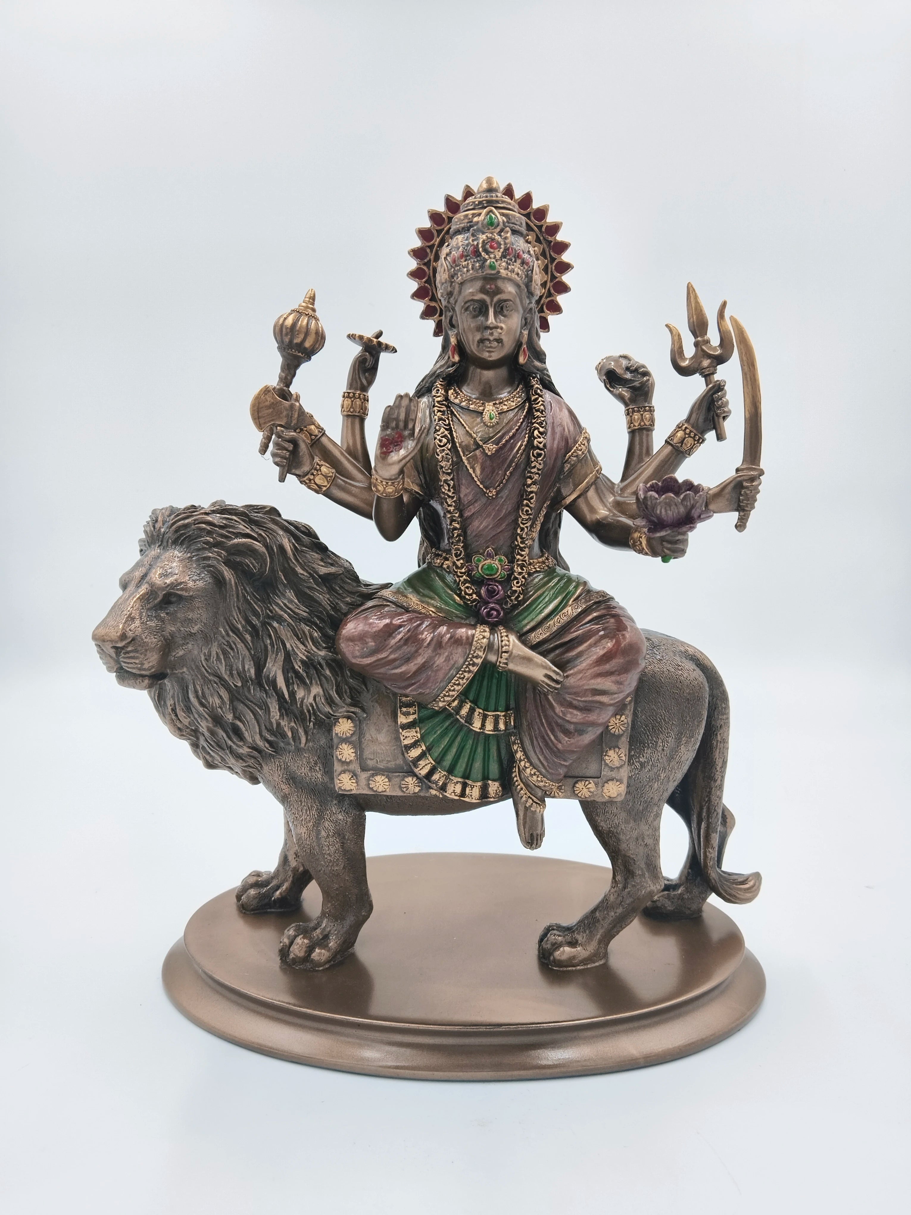Polyresin sculpture of Durga Maa sitting on a lion with multiple arms holding symbolic items