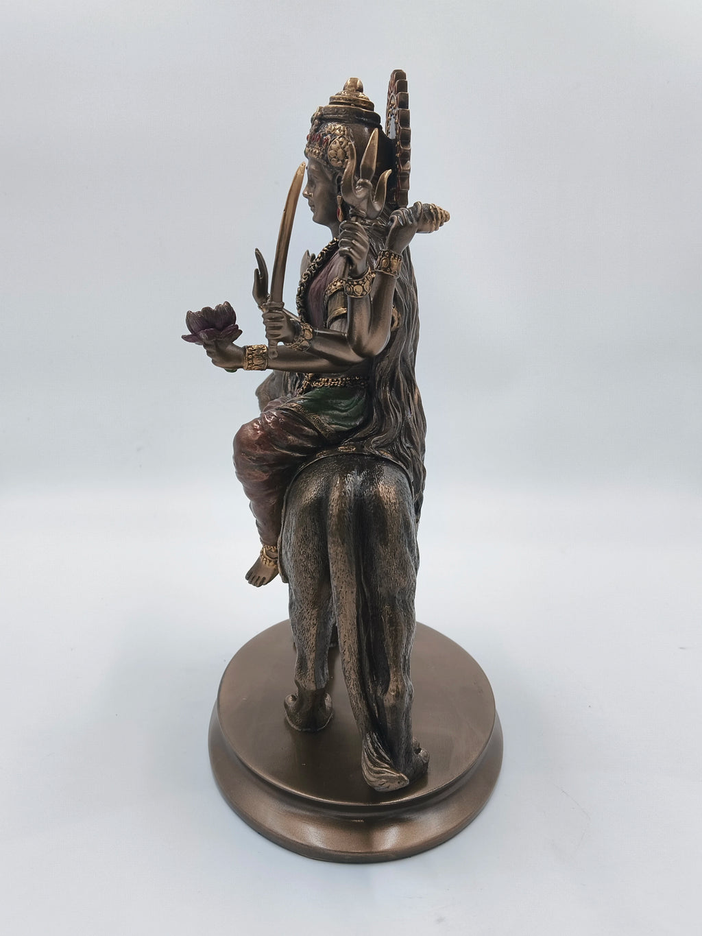 Side view of polyresin Durga Maa statue seated on a lion base