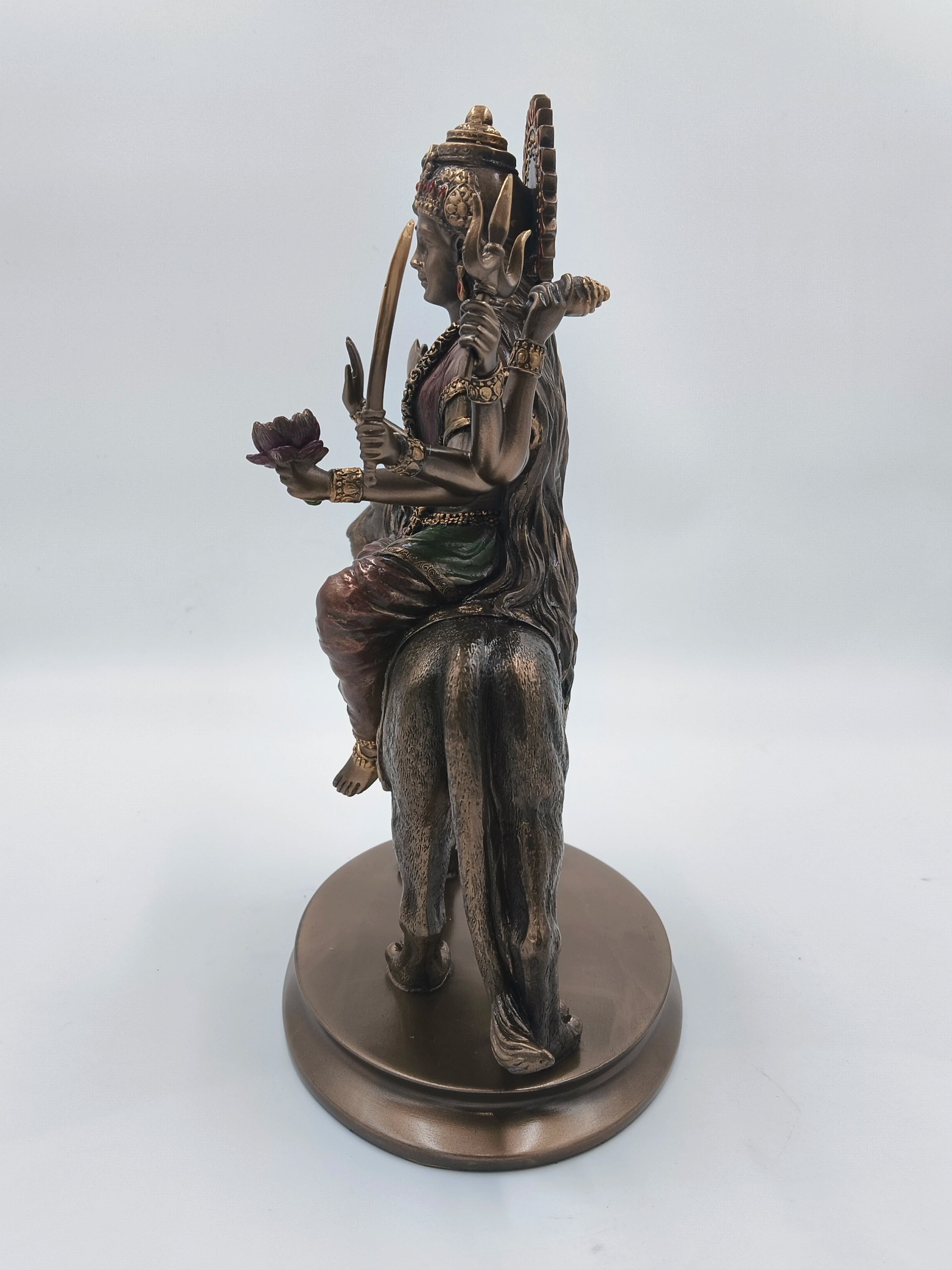 Side view of polyresin Durga Maa statue seated on a lion base