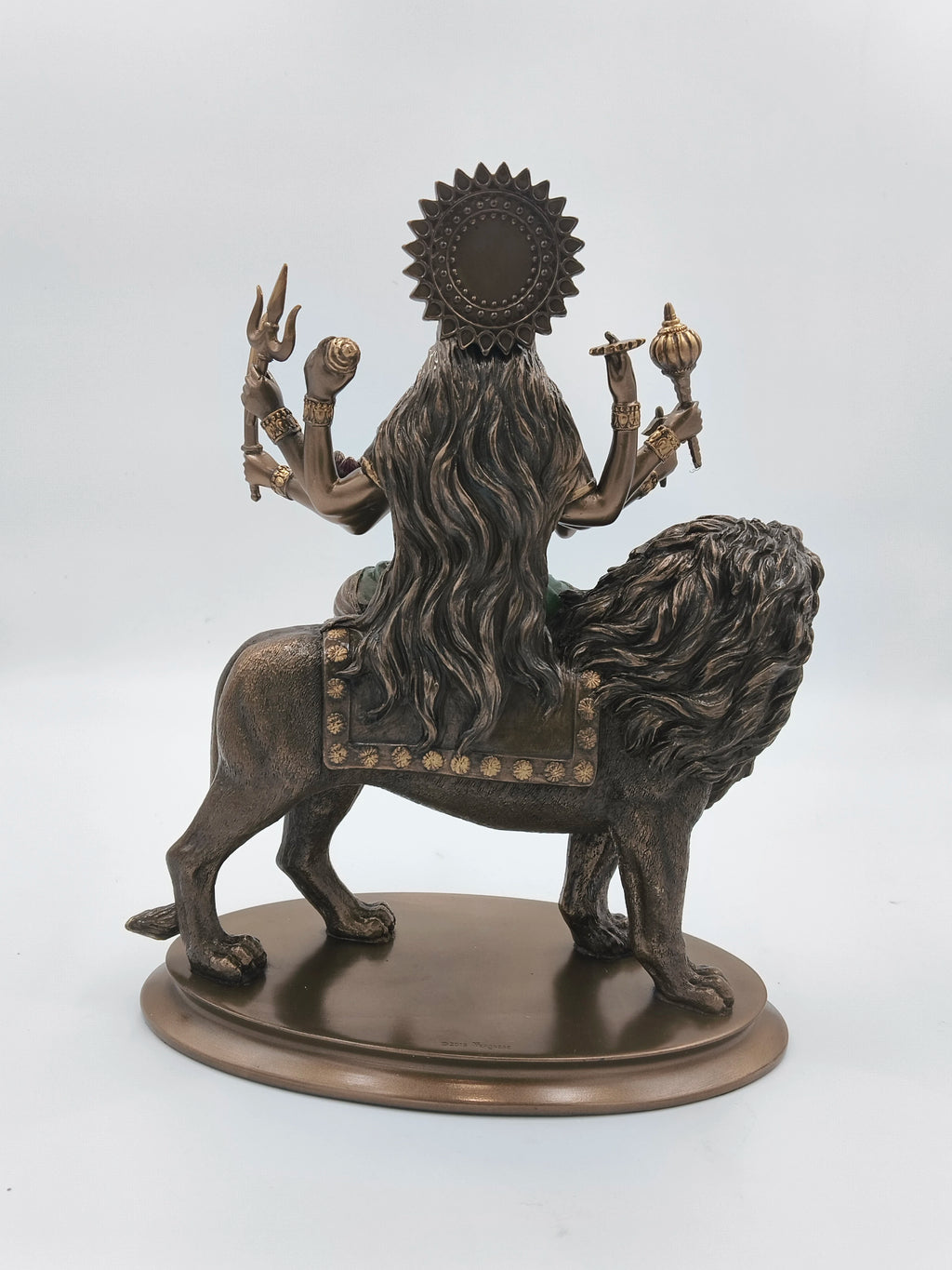 Back view of polyresin Durga Maa statue riding a lion with multiple arms