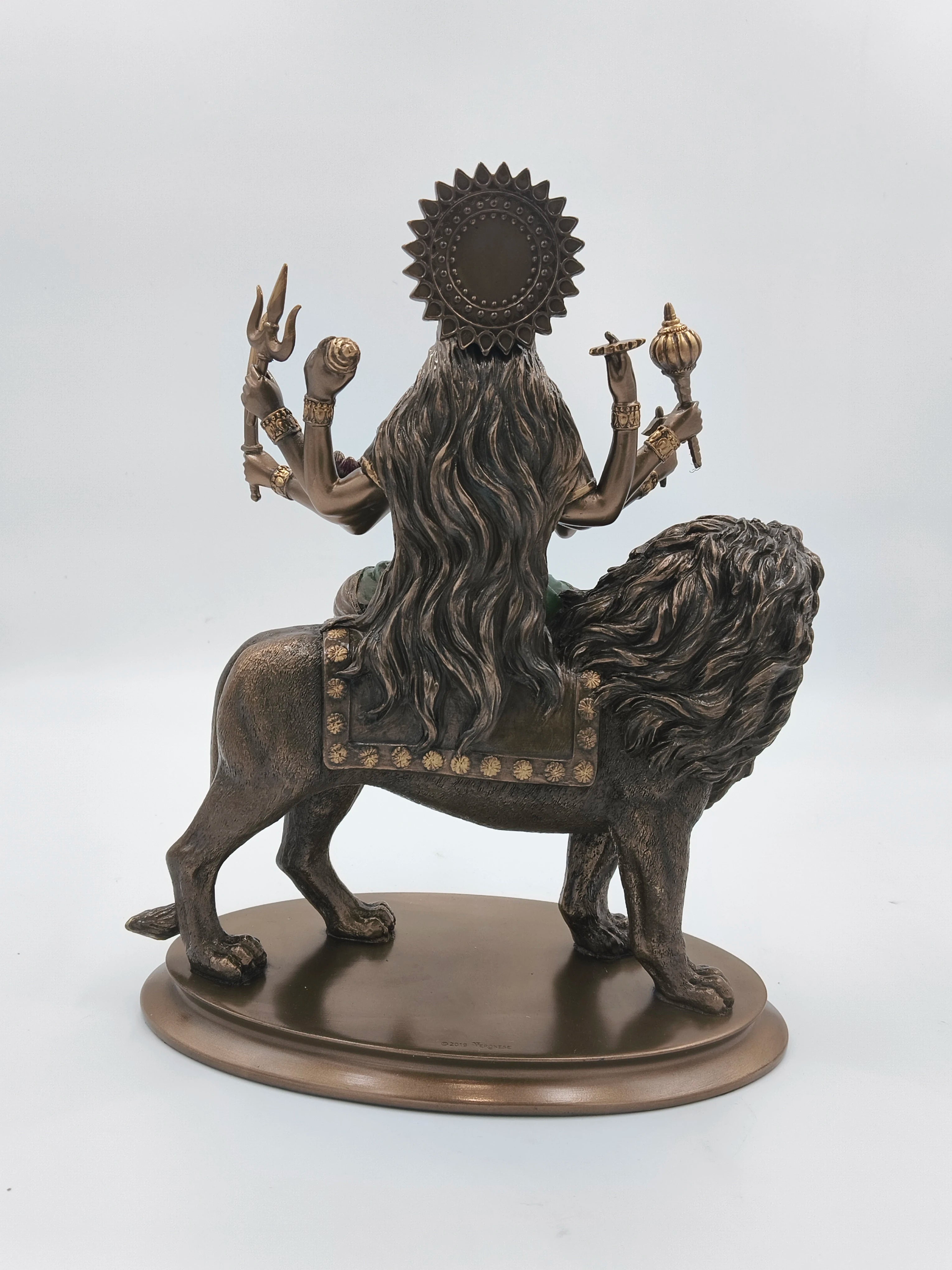 Back view of polyresin Durga Maa statue riding a lion with multiple arms