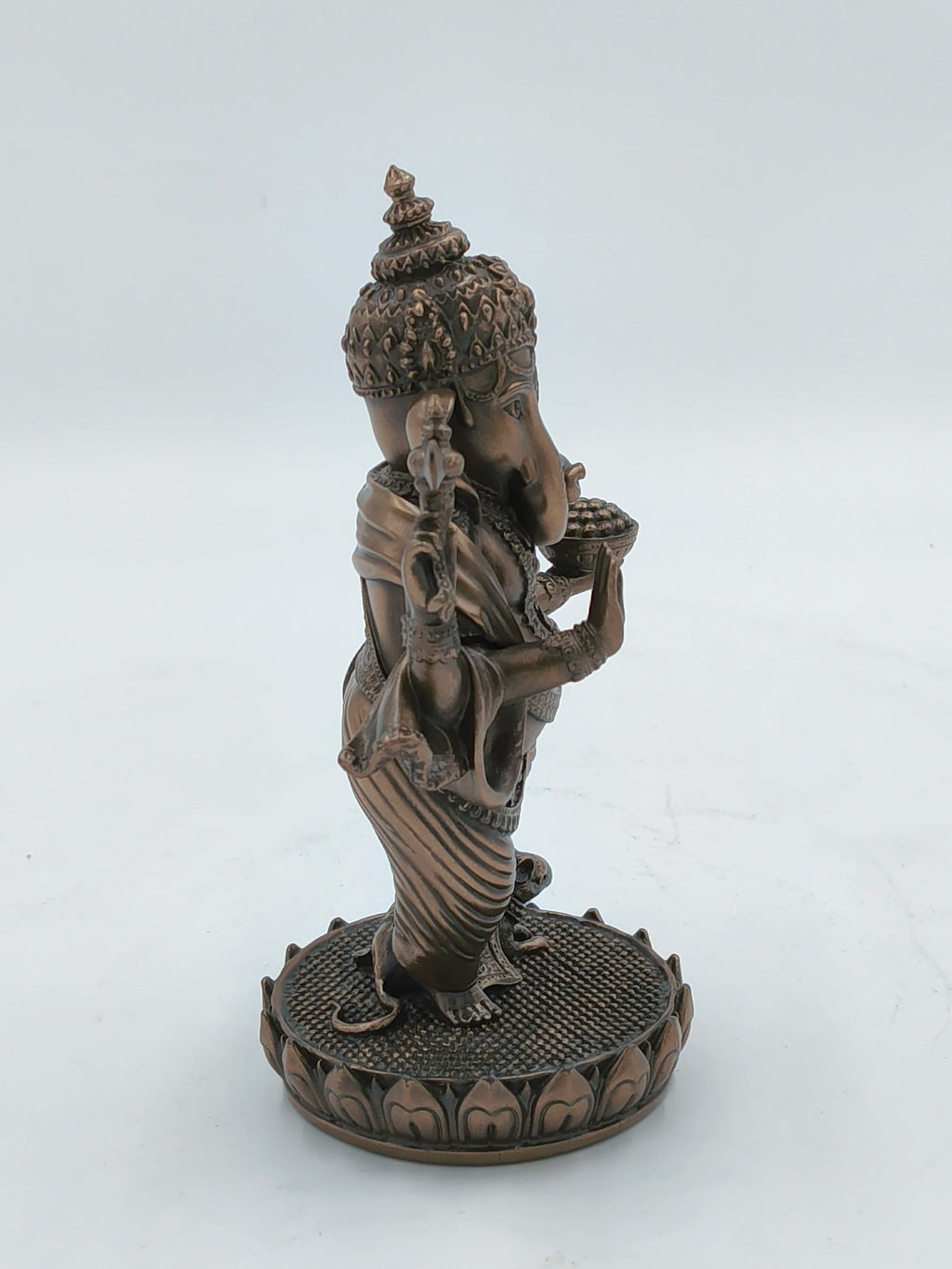 Side view of medium polyresin standing Ganesh statue on lotus base