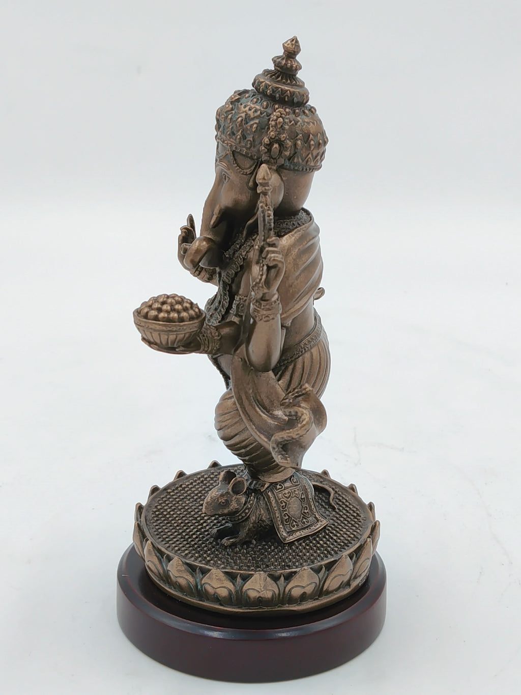 Side view of medium polyresin standing Ganesh statue on decorative base