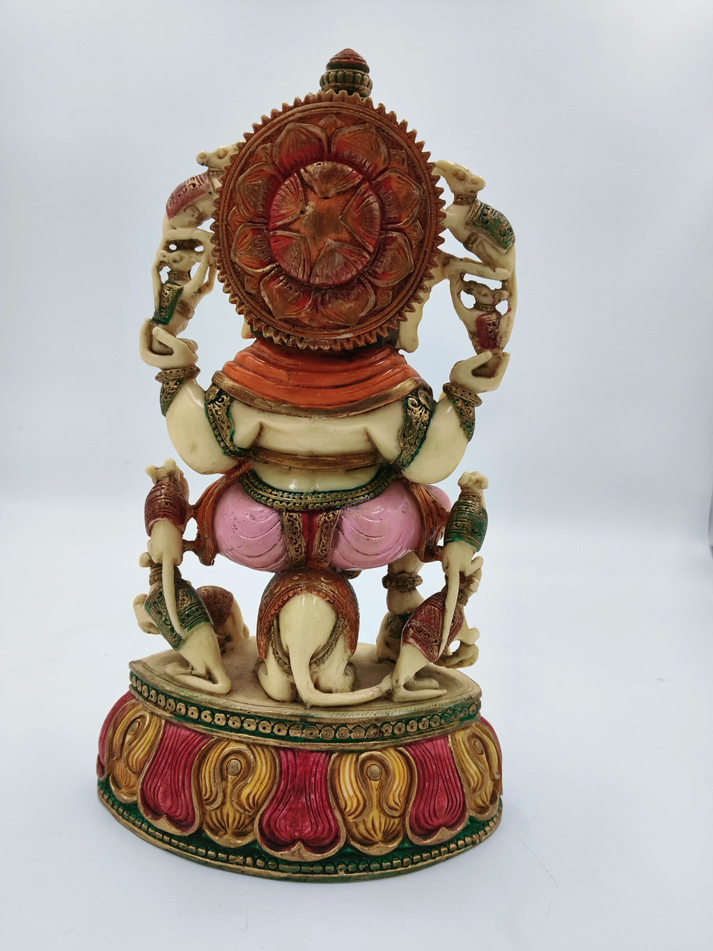 Back view of large polyresin Ganesh statue sitting on a decorated rat