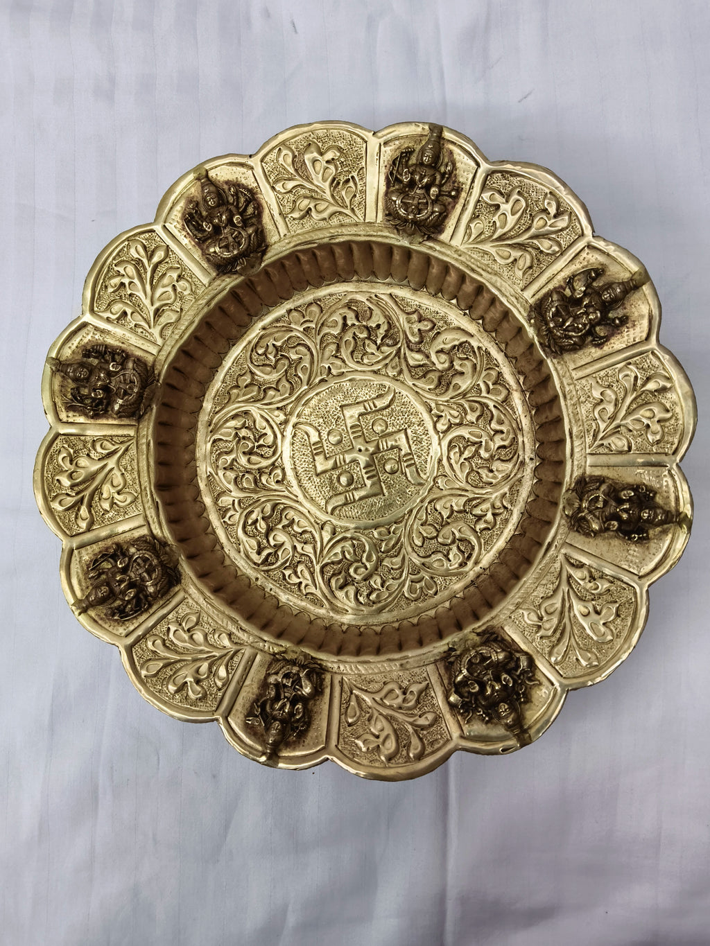 Mini brass decor plate with intricate floral patterns and Hindu deity figures