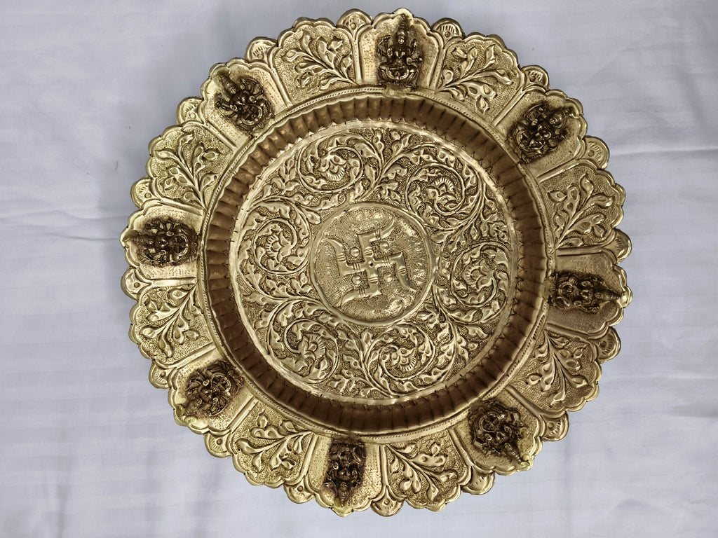 Mini brass decor plate with intricate floral and deity motifs, top view