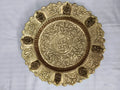 Mini brass decor plate with intricate floral and deity motifs, top view