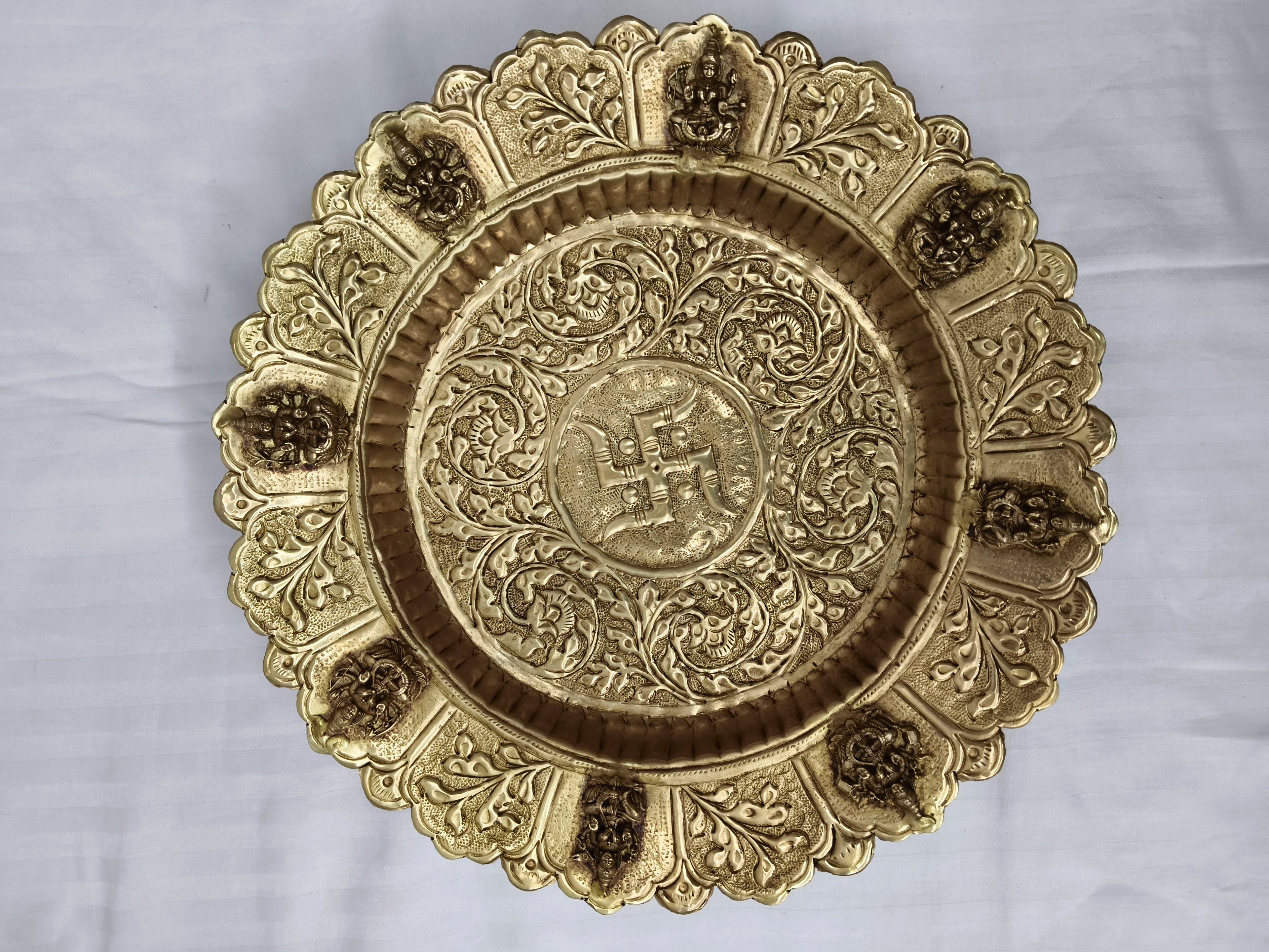 Mini brass decor plate with intricate floral and deity motifs, top view
