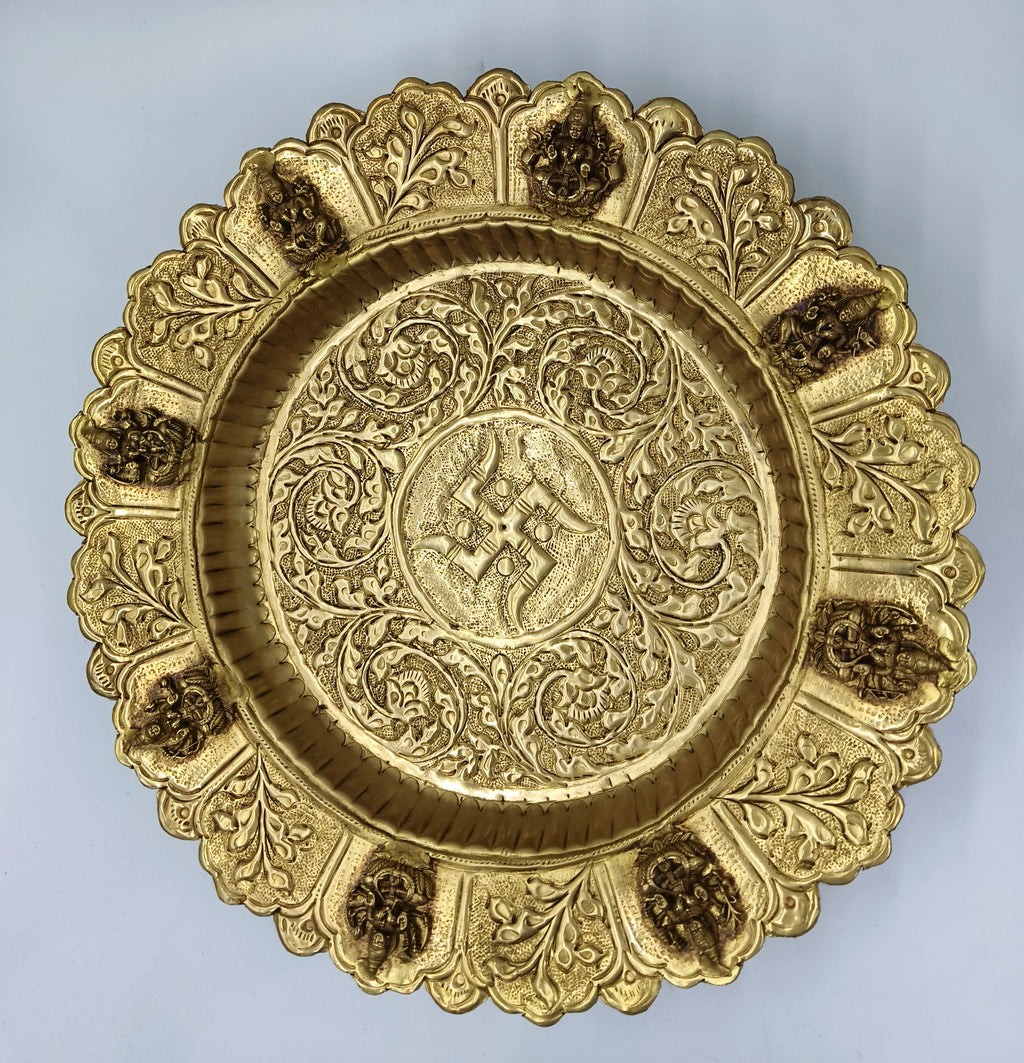 Mini brass decor plate with intricate floral and deity motifs, top view