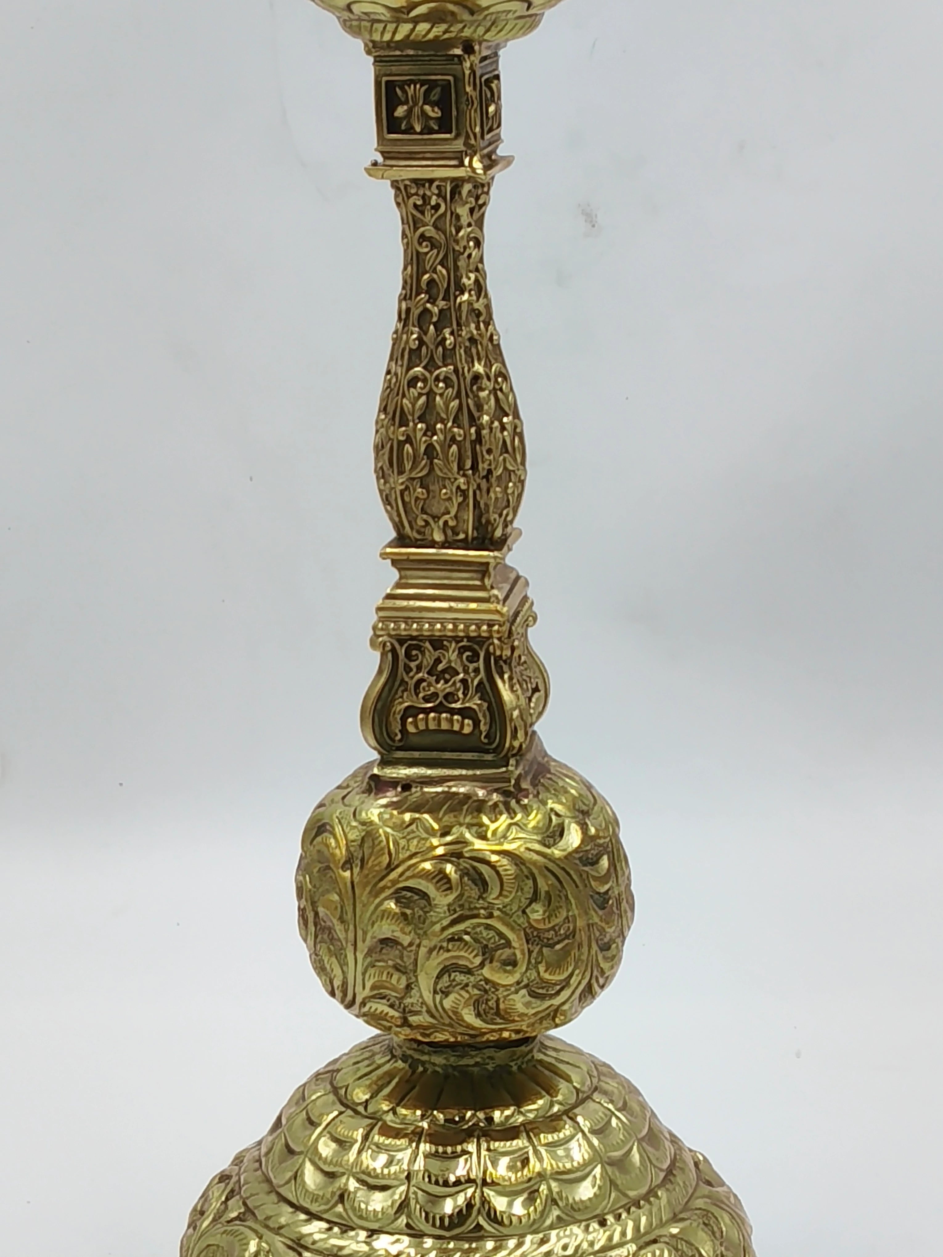 Close-up of a large brass lamp with intricate floral engravings