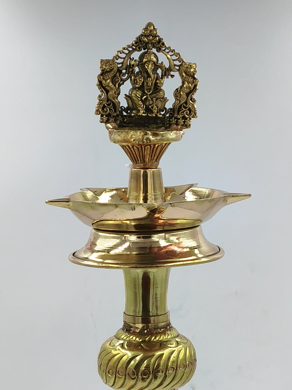 Large brass lamp with engraved Ganesha figure and ornamental base