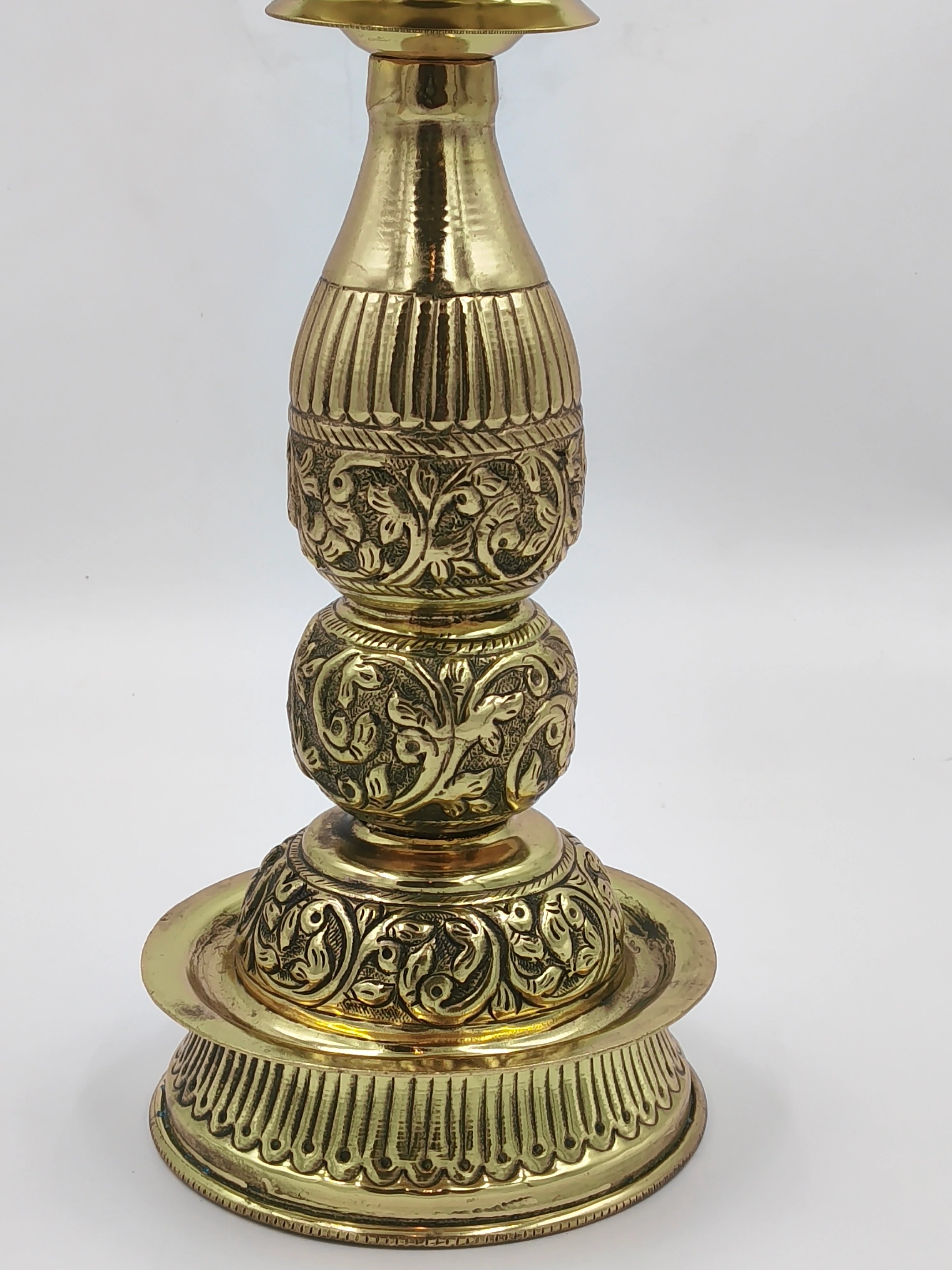 Large brass lamp with intricate floral engravings and polished finish