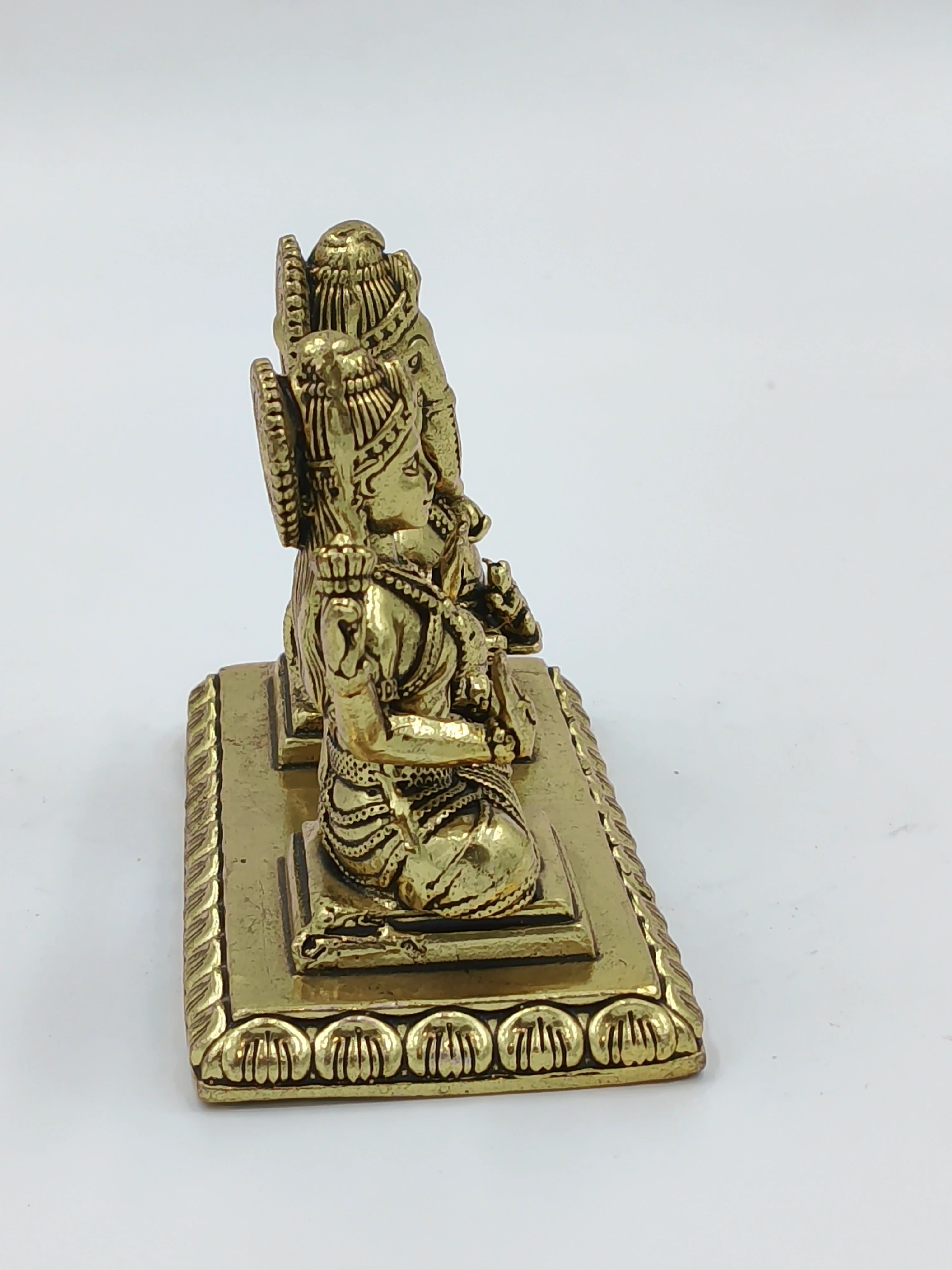 Small brass tabletop sculpture of Lakshmi and Ganesh deities side view