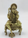 Brass statue of Hanuman sitting cross-legged on an ornate chowki