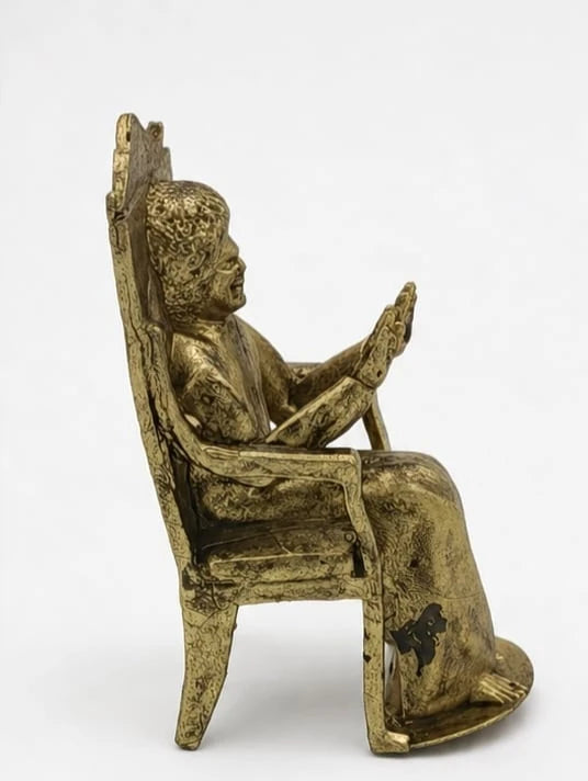 Brass sculpture of Sai Baba sitting on a detailed chair side view