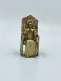Small brass sculpture of Sai Baba sitting on a chair with hands raised