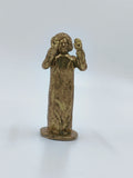 Small brass Sai Baba statue with raised hands on a flat base