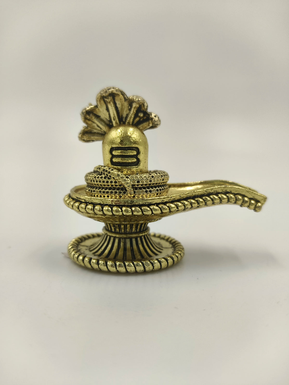 Compact brass Shivalinga sculpture with snake and decorative base