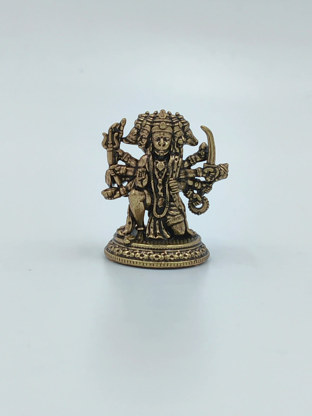 Mini brass Panchamukhi Hanuman sculpture with multiple arms holding weapons