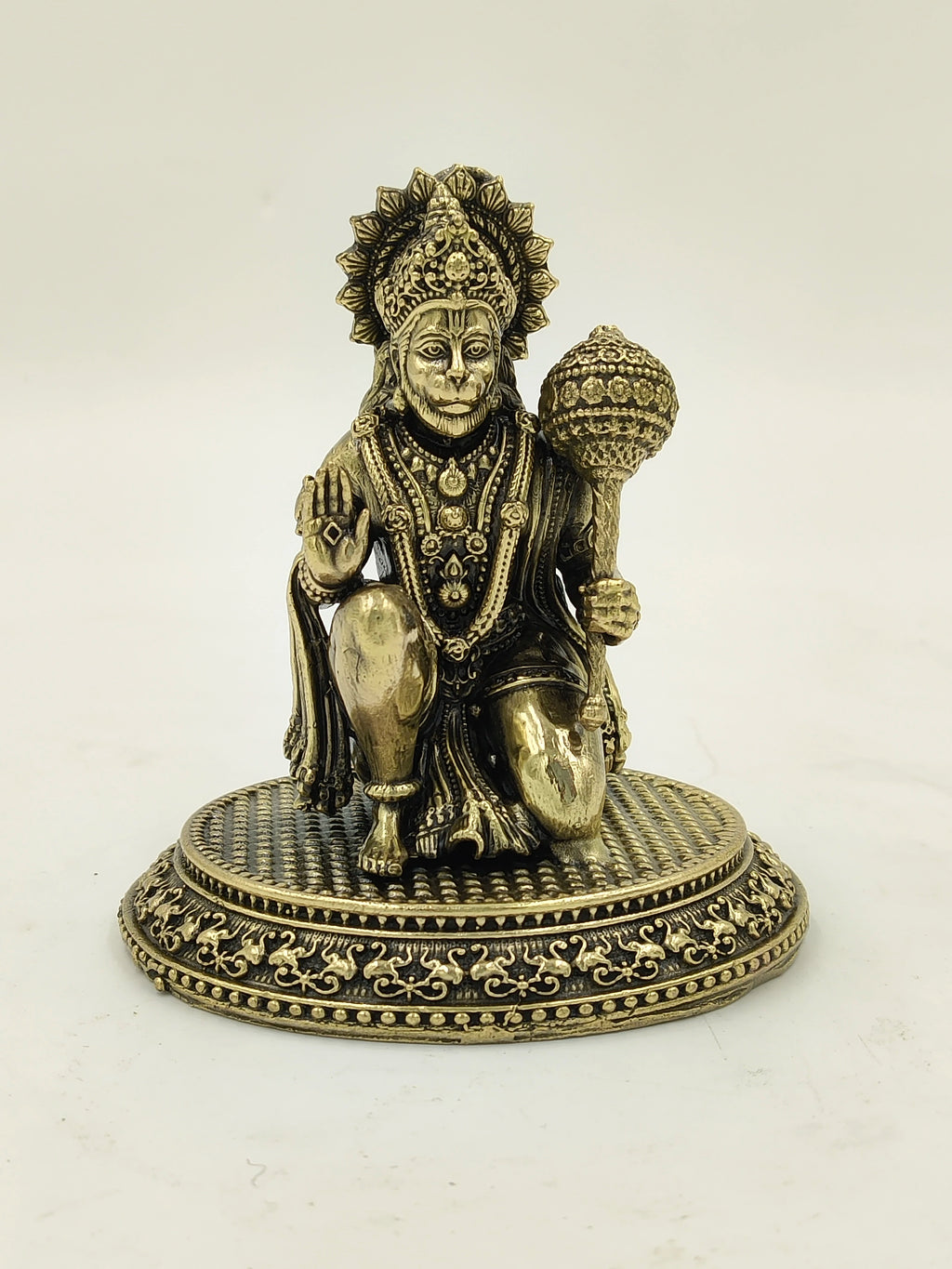 Small brass Hanuman statue kneeling with mace on ornate base
