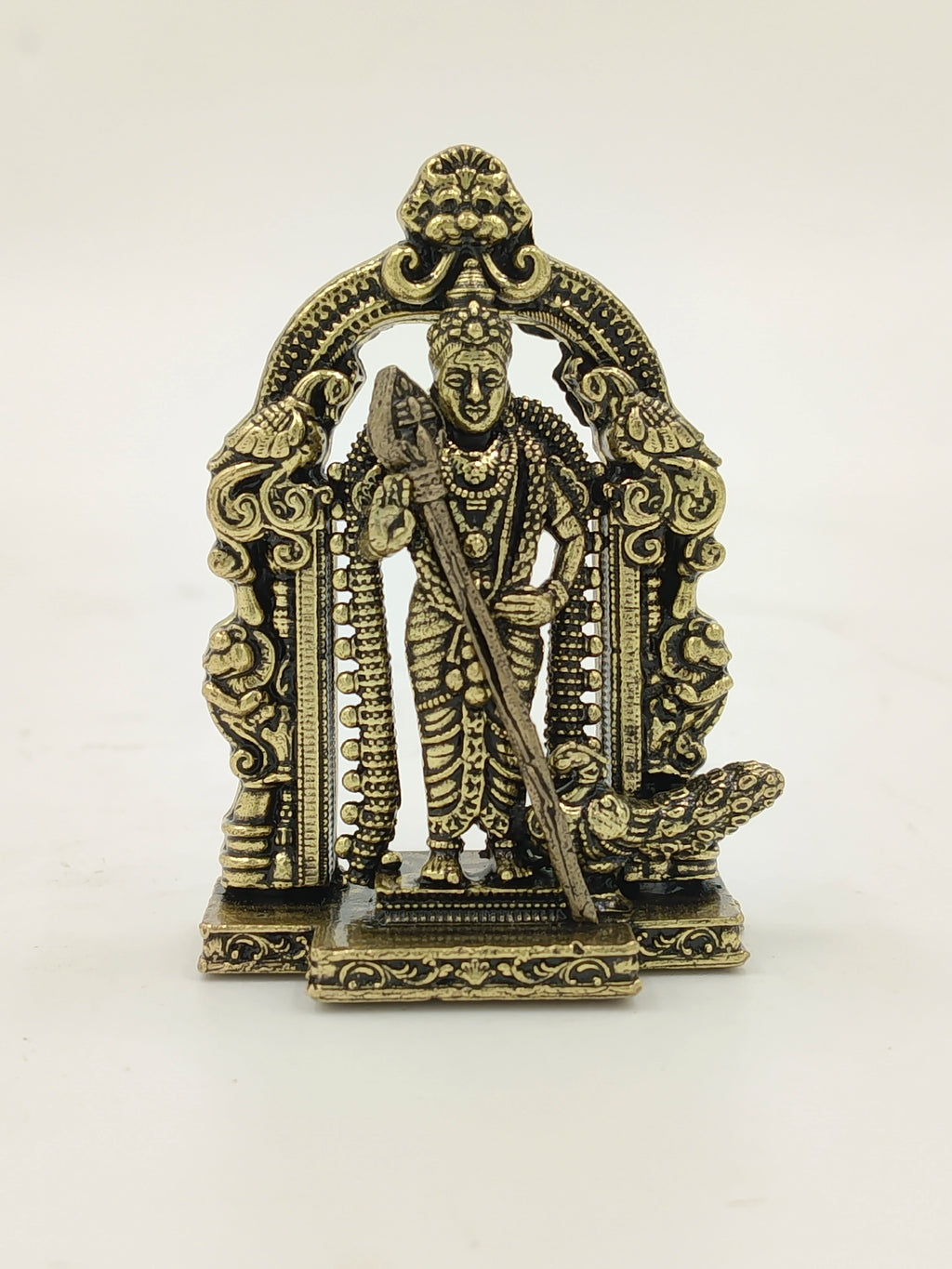 Mini brass statue of deity Murgan under an ornate arch