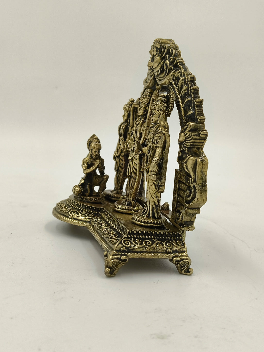 Small brass Ram Parivar sculpture with intricate designs and standing deities