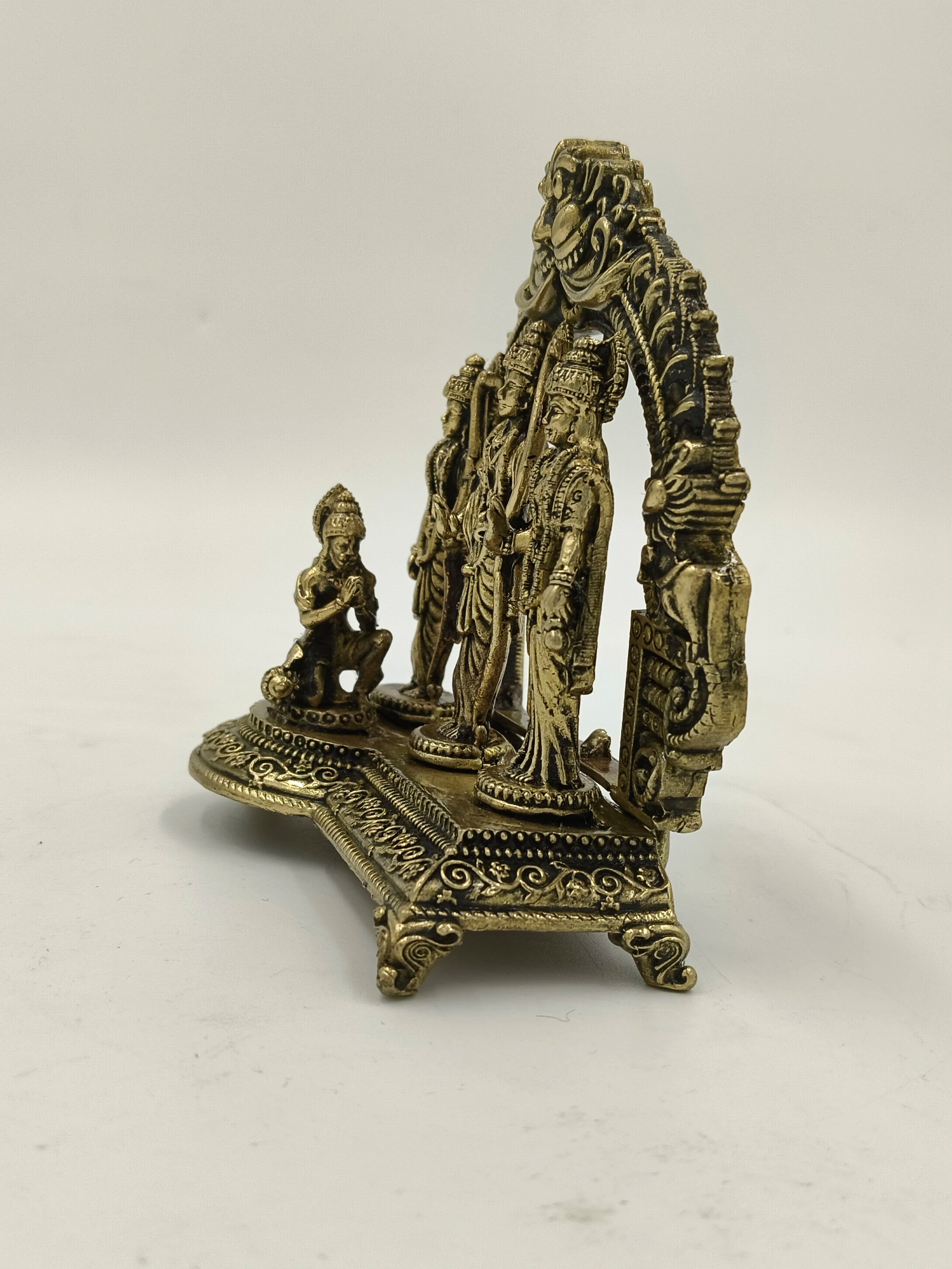 Small brass Ram Parivar sculpture with intricate designs and standing deities