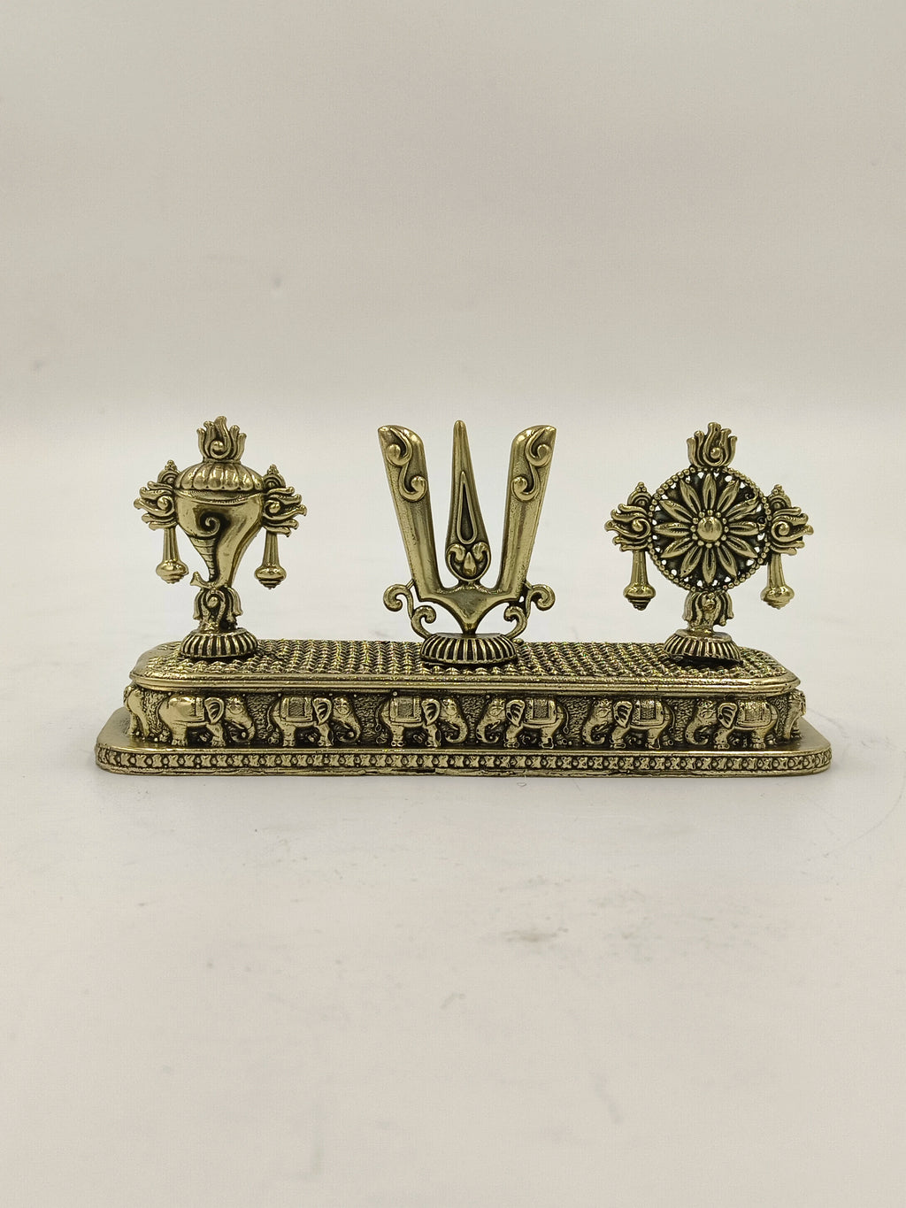 Mini brass sculpture featuring Shankh, Chakra, and Namah symbols on a decorative base