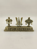 Mini brass sculpture featuring Shankh, Chakra, and Namah symbols on a decorative base