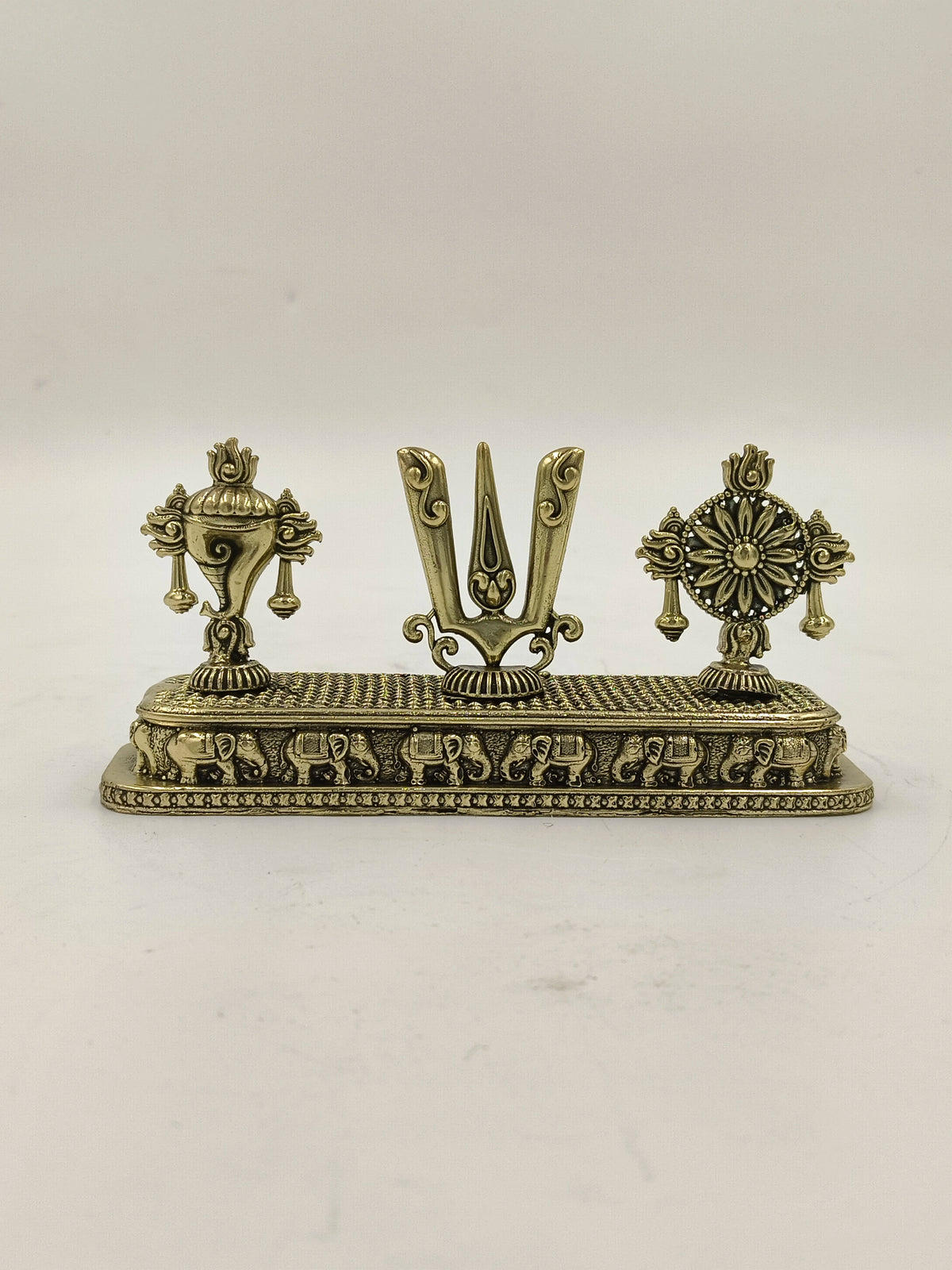 Mini brass sculpture featuring Shankh, Chakra, and Namah symbols on a decorative base