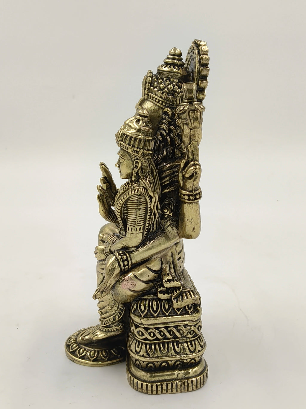 Side view of medium-sized brass Narasimha sculpture with detailed carvings