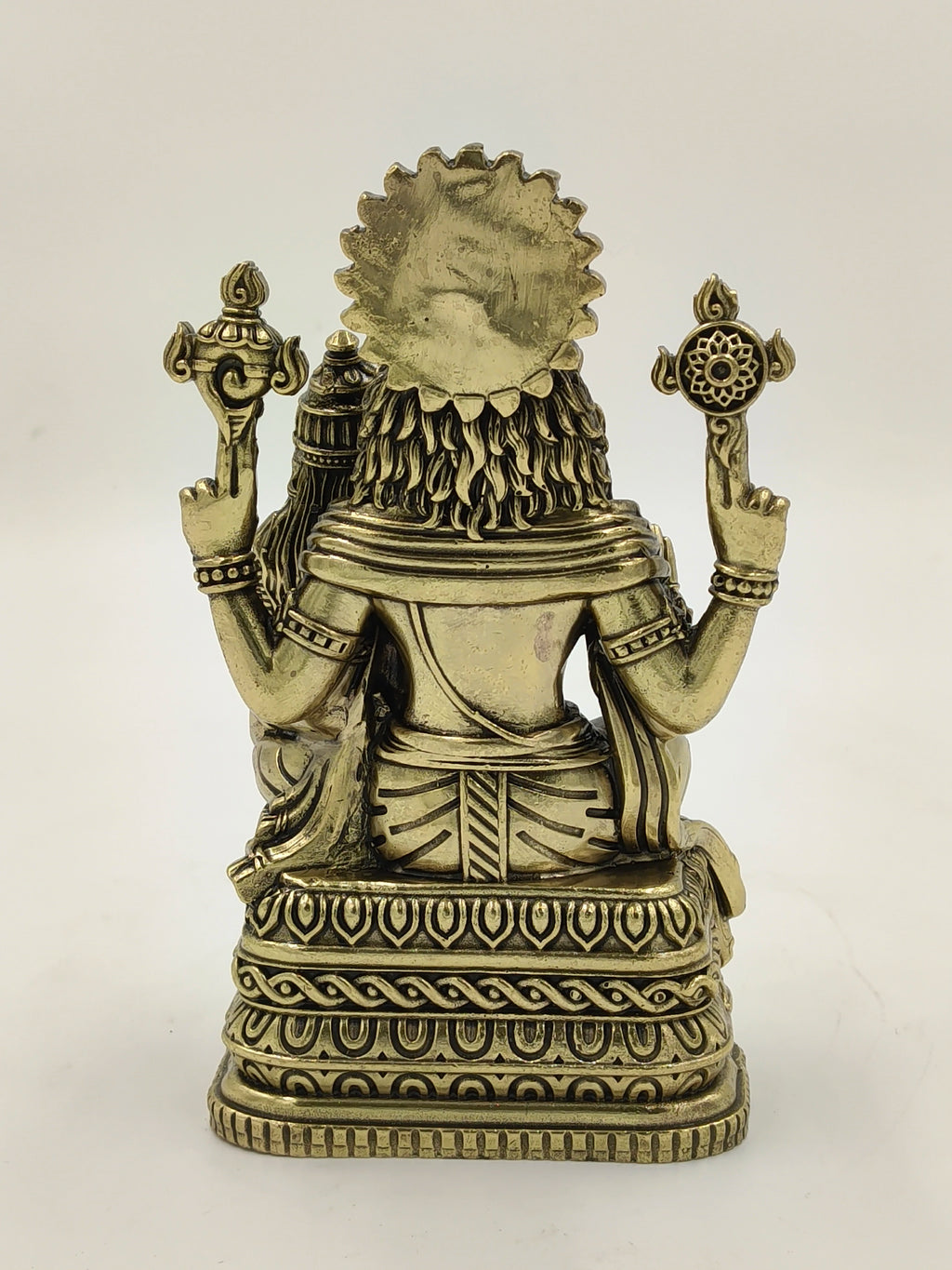 Back view of medium brass Narasimha sculpture with intricate detailing