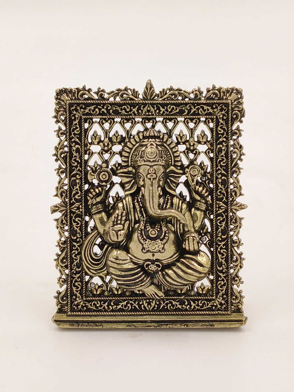 Small brass Ganesh panel with intricate decorative border and detailing
