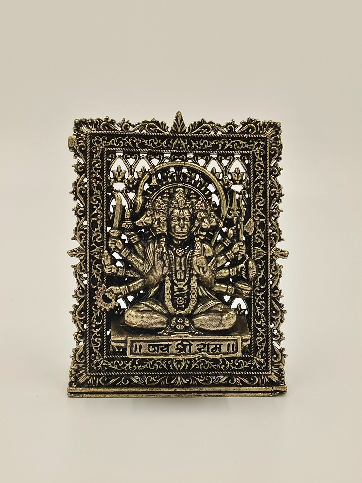 Small brass Panchamukhi Hanuman panel with intricate floral border and inscriptions