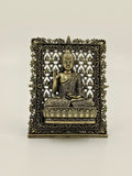 Small brass Buddha panel sculpture with ornate floral frame and lotus seat