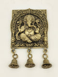 Large brass square frame featuring seated Ganesh with intricate floral details and three hanging bells