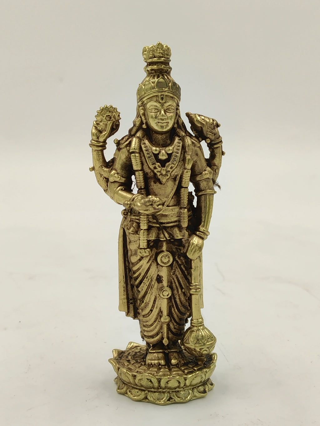 Small brass Vishnu statue standing on a lotus base with four arms