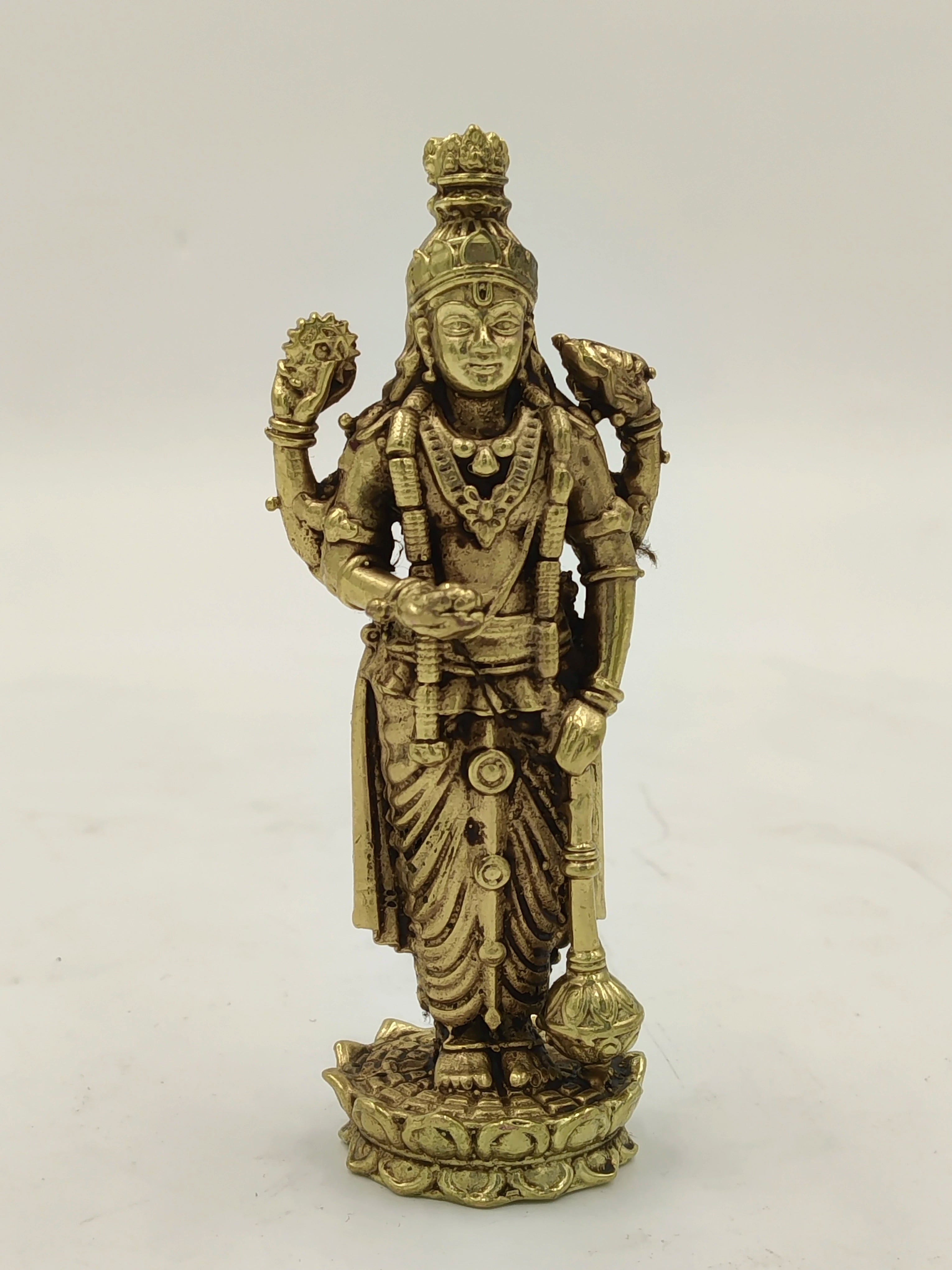 Small brass Vishnu statue standing on a lotus base with four arms