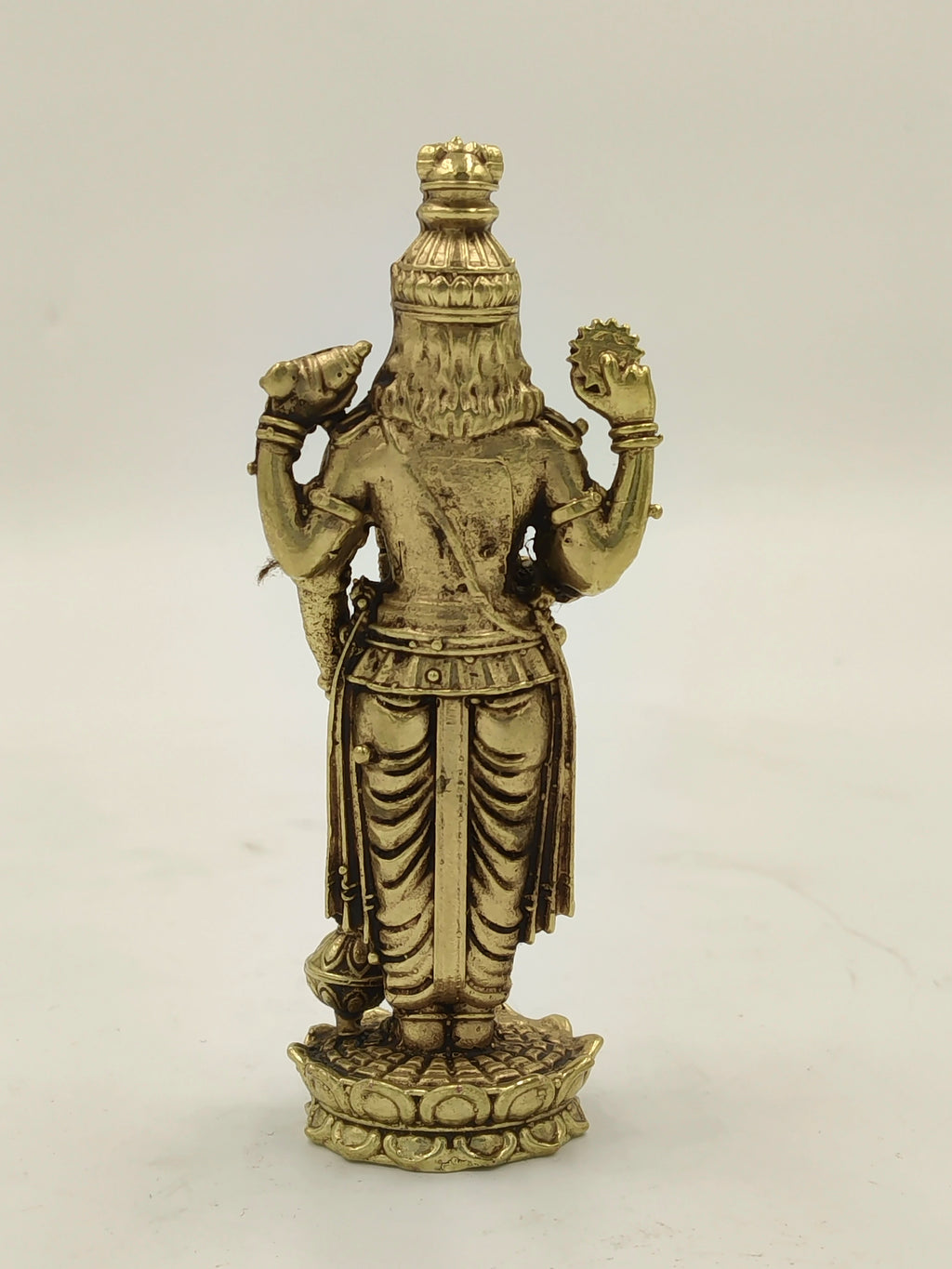 Rear view of small brass Vishnu statue standing on lotus base