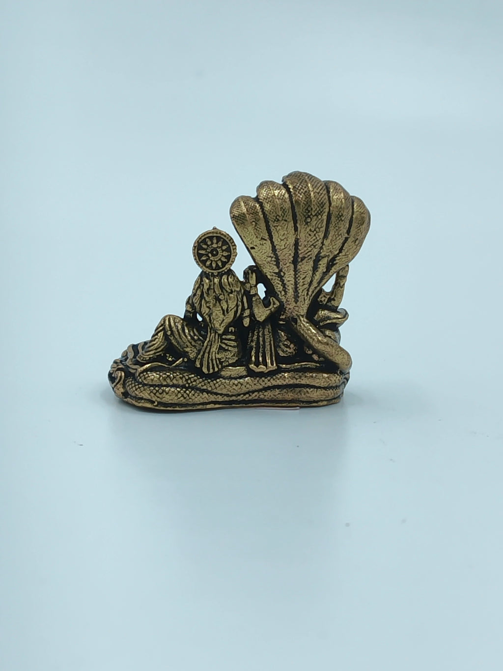 Mini brass sculpture of Vishnu and Lakshmi seated under a serpent canopy