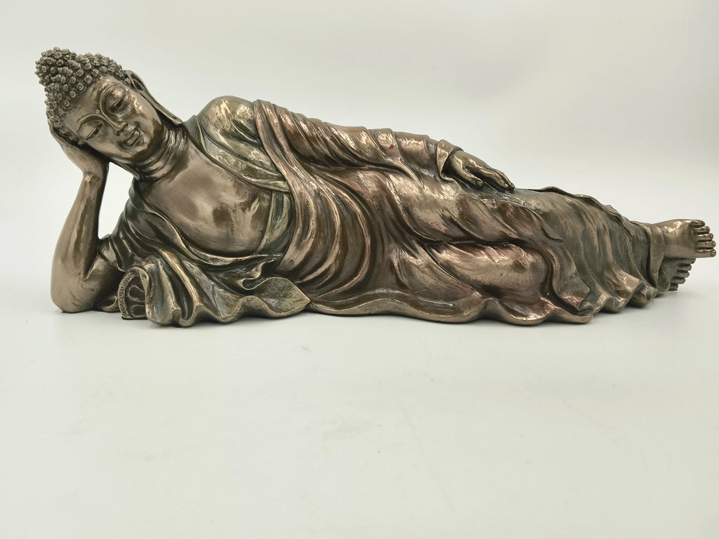 Medium-sized polyresin reclining Buddha sculpture with detailed draped robes