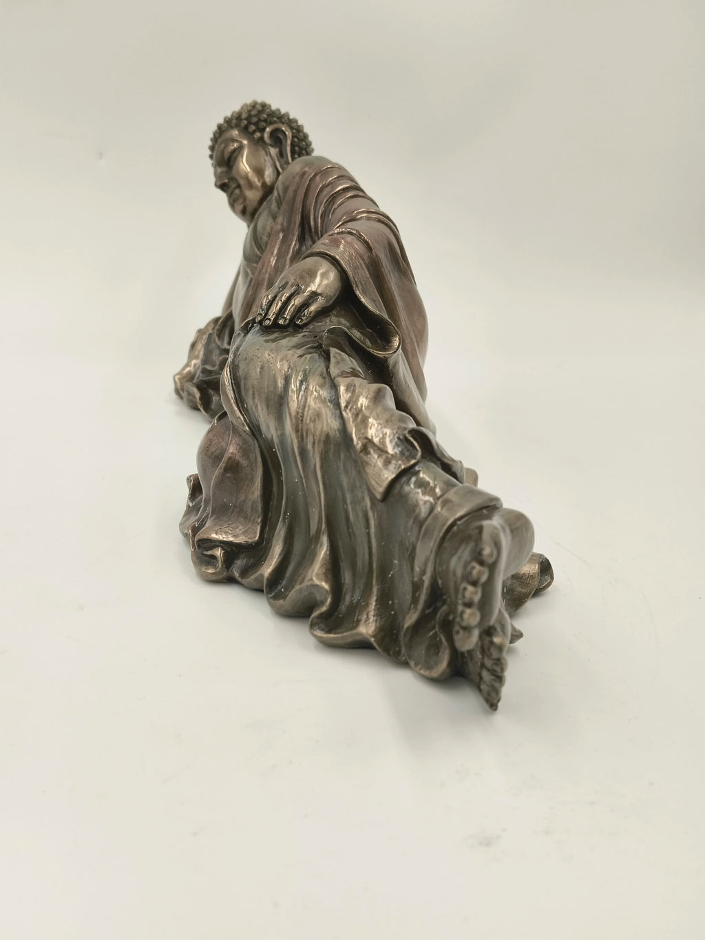Polyresin reclining Buddha statue with detailed robe and serene expression