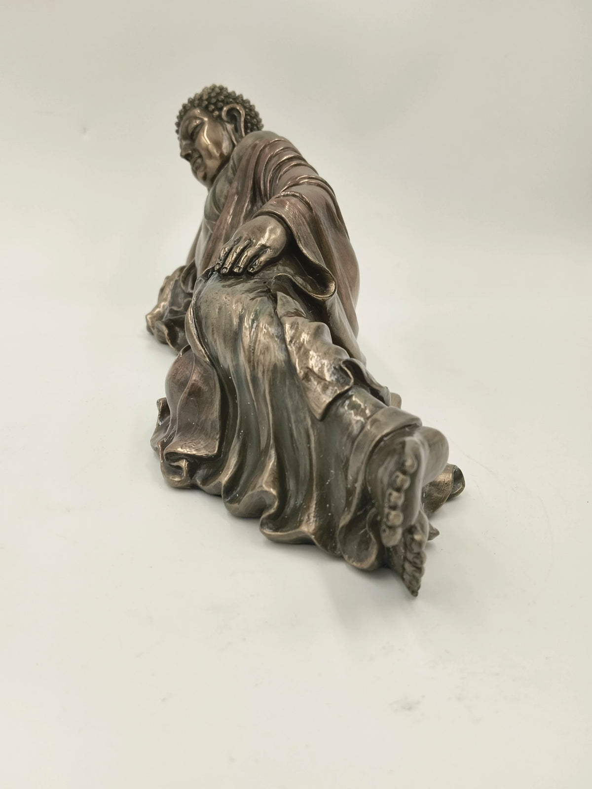 Polyresin reclining Buddha statue with detailed robe and serene expression